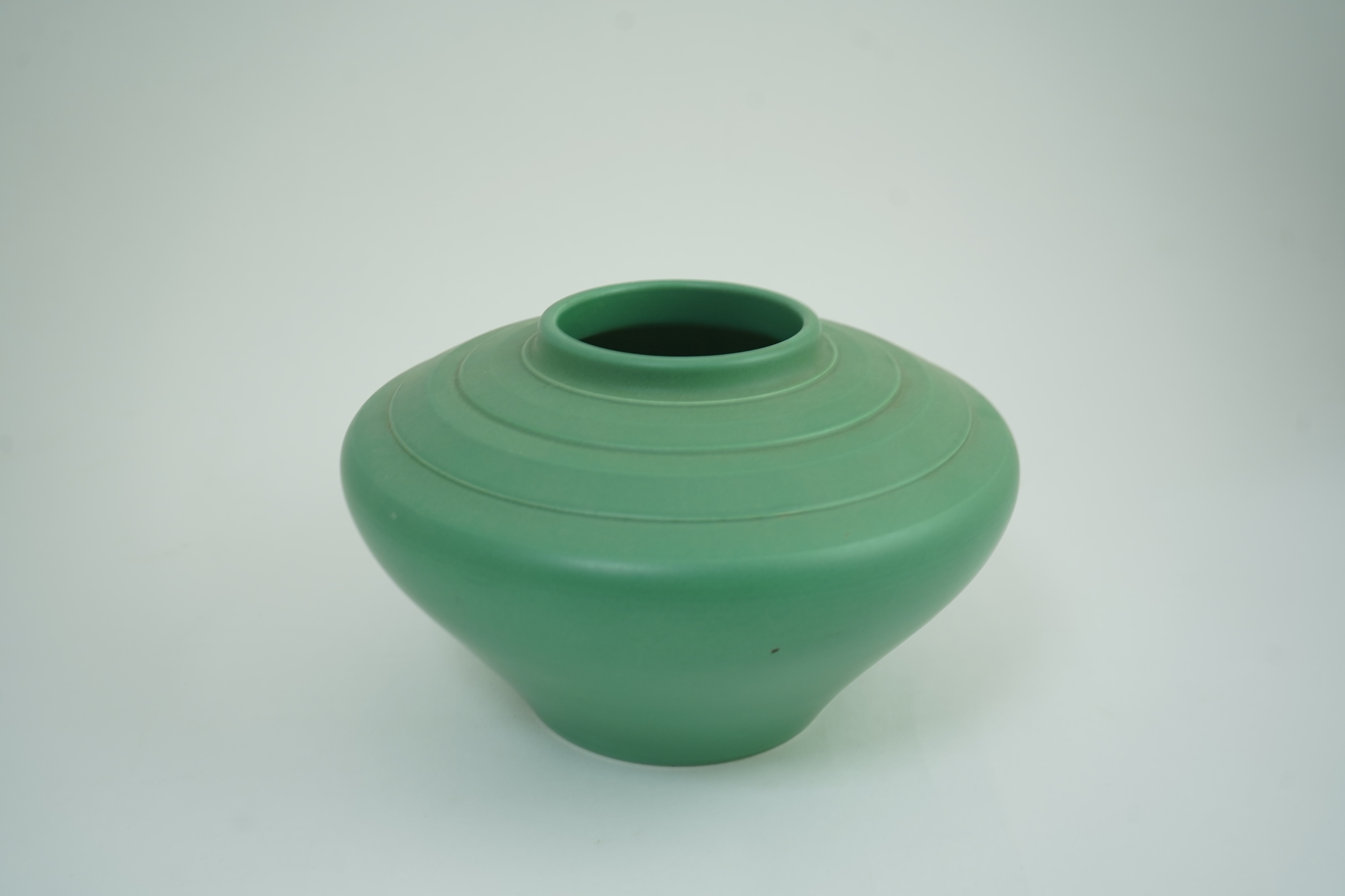 Keith Murray MC RDI FRIBA (New Zealand/British, 1892-1981) for Wedgwood: A matt green glazed angular vase